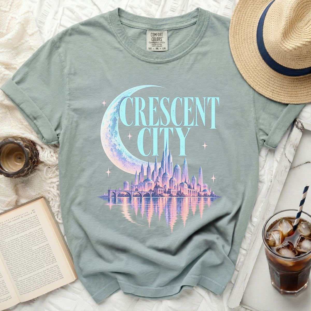 Green t-shirt with "CRESCENT CITY" and a fantasy cityscape graphic.