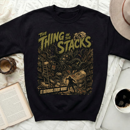 Black sweatshirt with "The Thing in the Stacks" and a monster.
