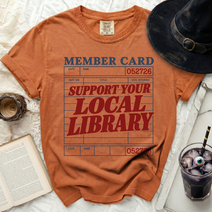 Orange shirt with "Member Card" and "Support Your Local Library" text design.