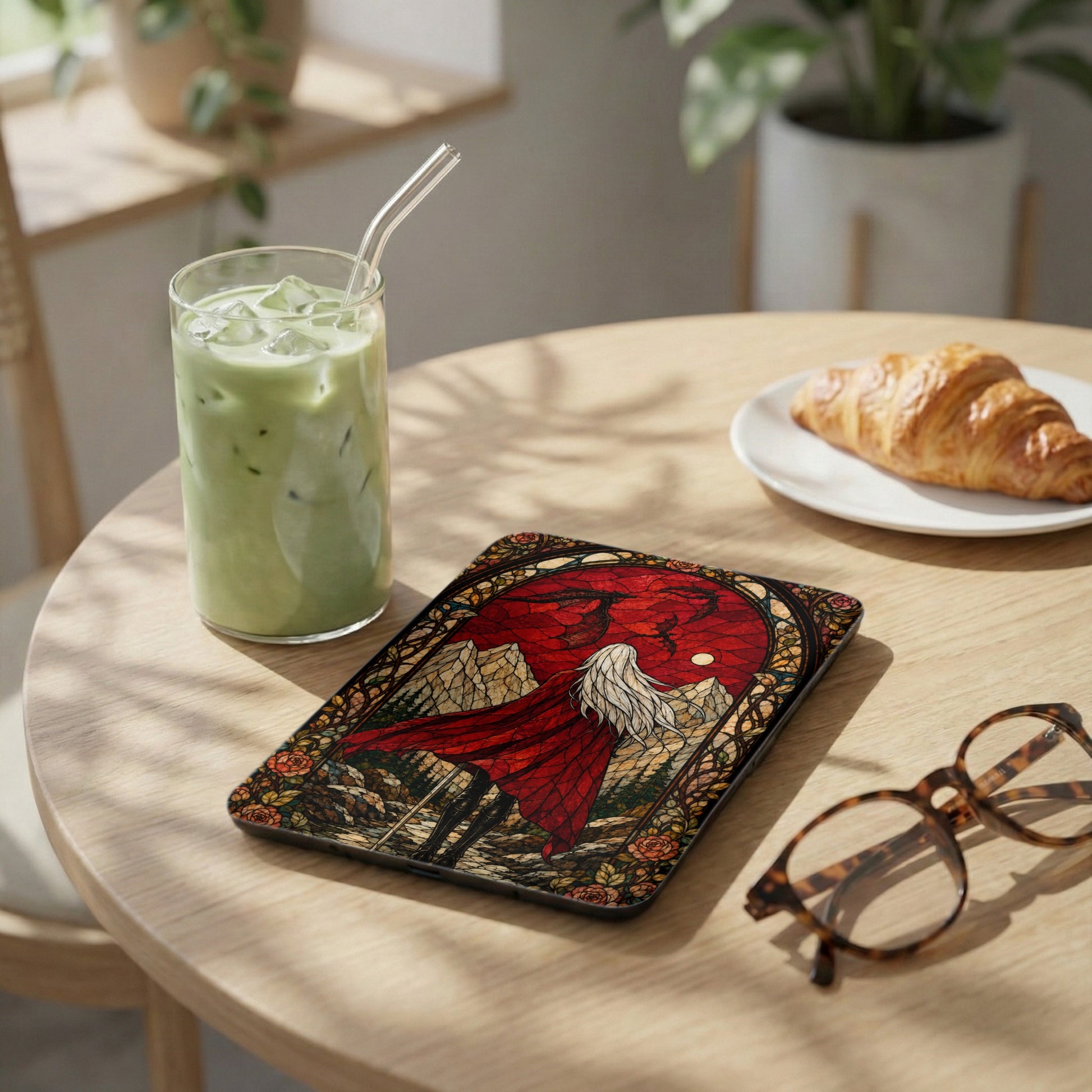 Tablet case with stained glass art of a figure in a red cloak and dragons.