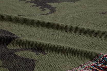 a close-up view of a textured fabric with a dragon design on it. The dragon appears to be a dark silhouette against a lighter background, creating a striking contrast.
