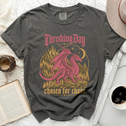 Graphic t-shirt with a pink dragon, castle, and trees. Text reads "Threshing Day chosen for chaos".