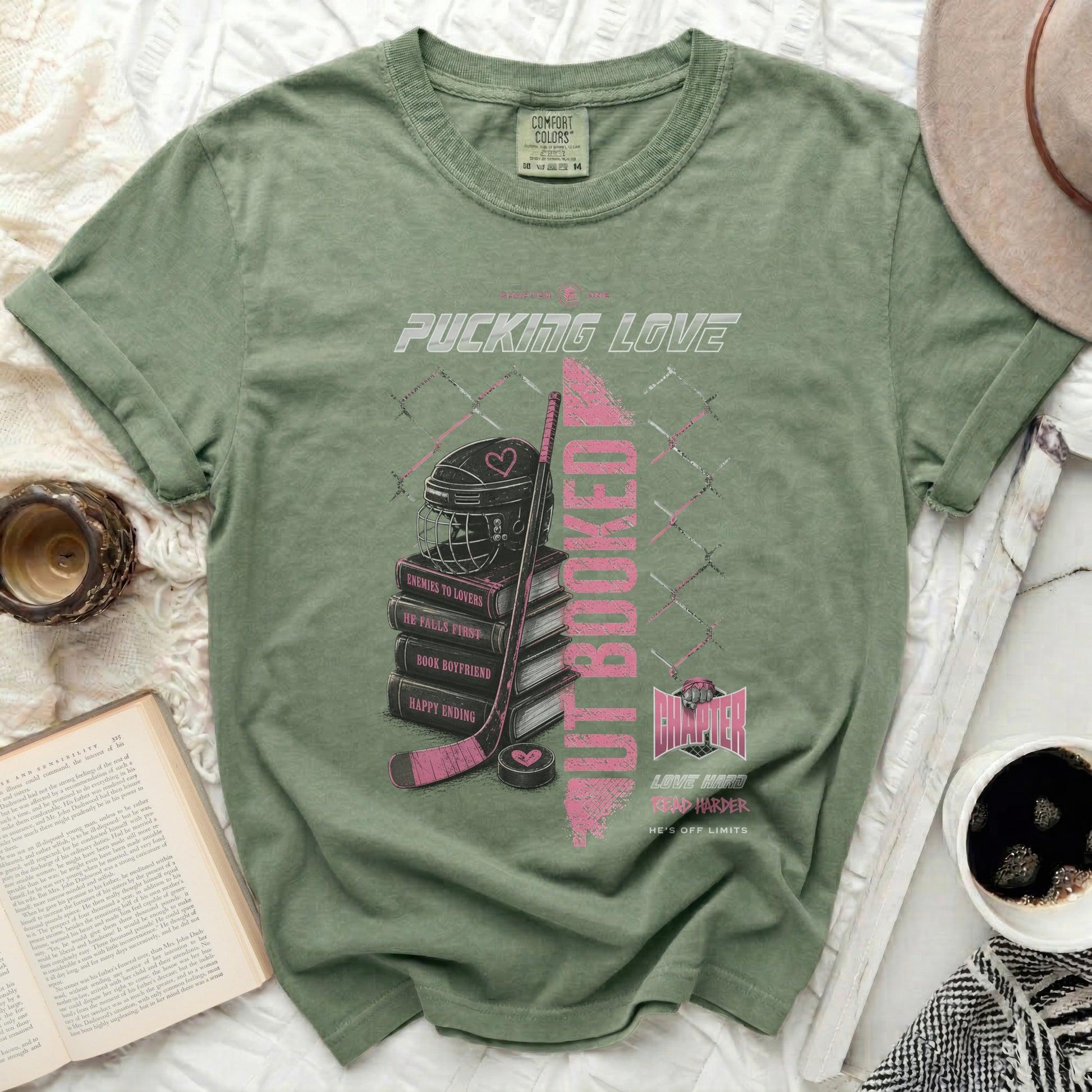 Green t-shirt with pink text and hockey theme: "Pucking Love" and "But Booked".