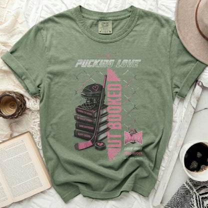 Green t-shirt with pink text and hockey theme: "Pucking Love" and "But Booked".
