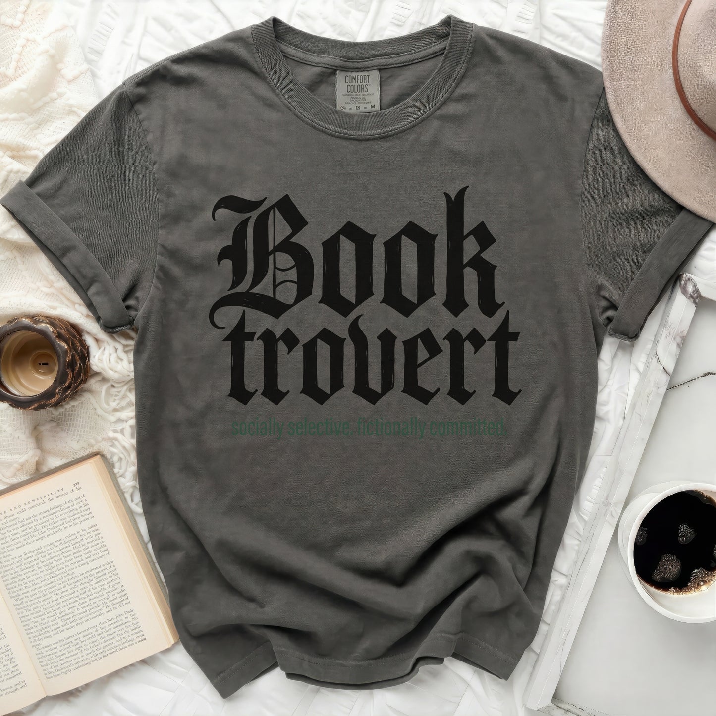 Dark grey t-shirt with "Booktrovert" in gothic font and "socially selective. fictionally committed."