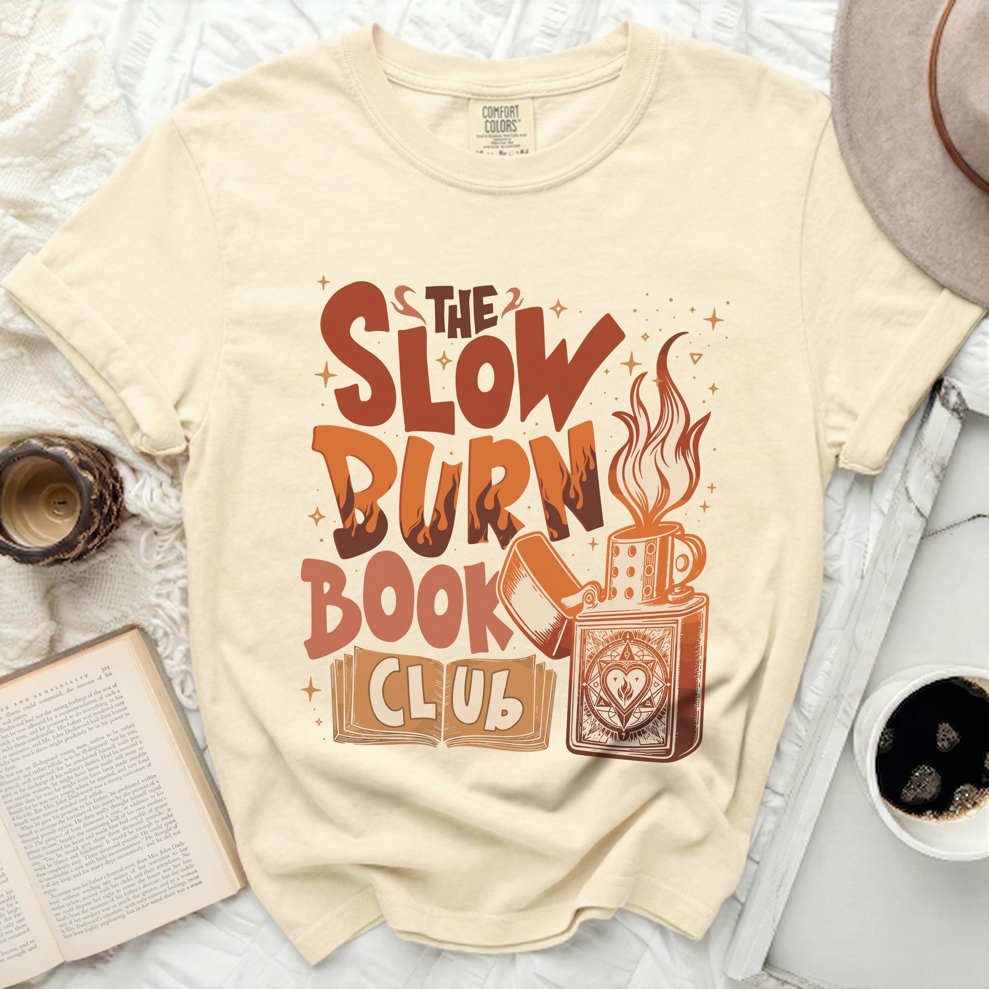 The Slow Burn Book Club t-shirt with graphic of a lighter, mug, and book.
