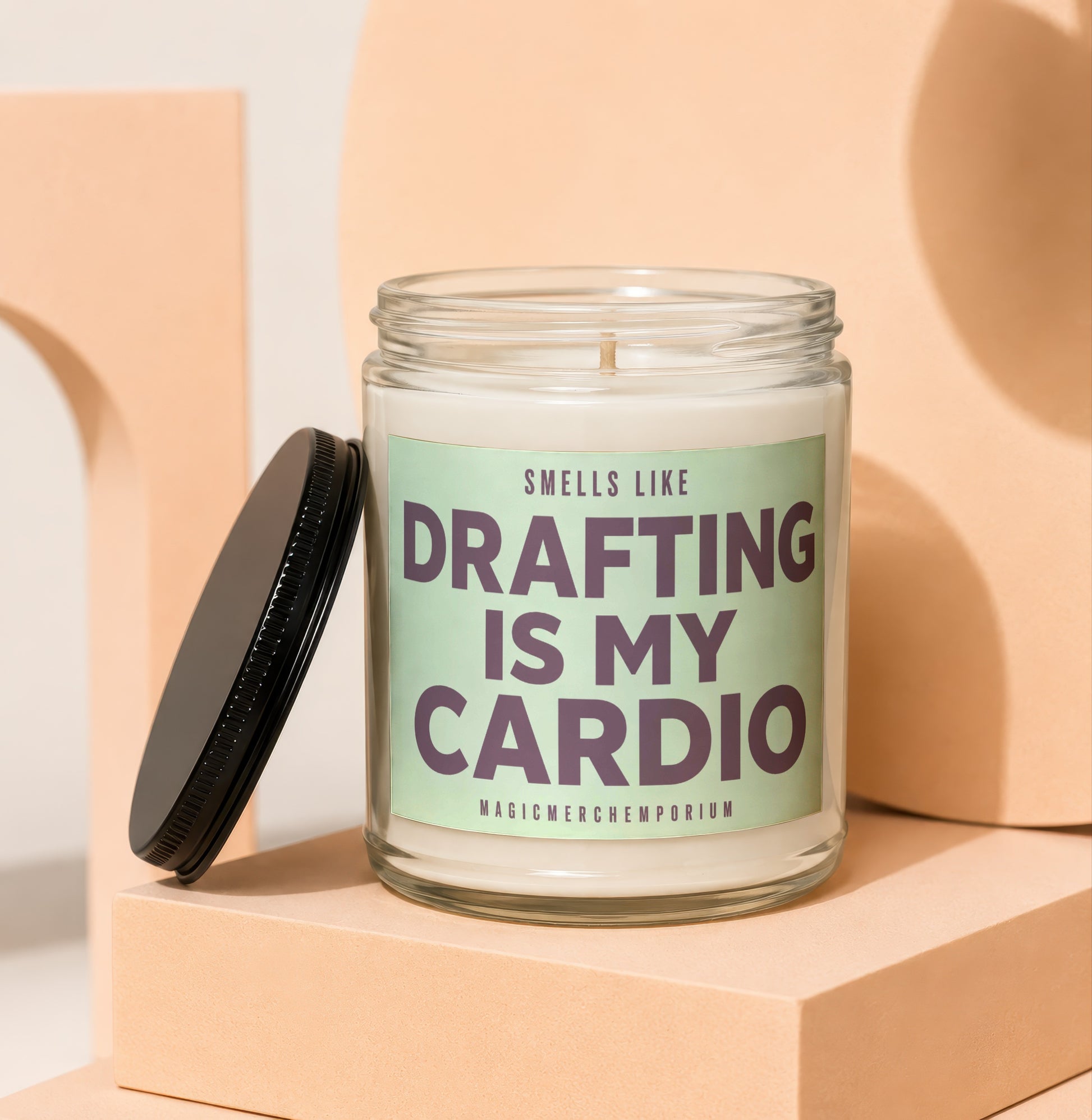 Glass candle with "Smells like Drafting is my Cardio" text and a black lid.
