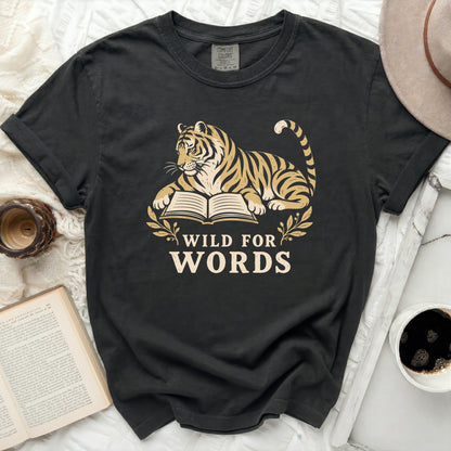 Tiger laying on an open book with text "WILD FOR WORDS".