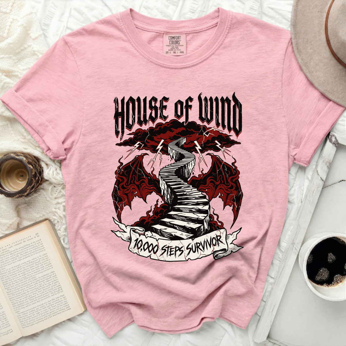 Pink t-shirt with "House of Wind" and "10,000 Steps Survivor" graphic.
