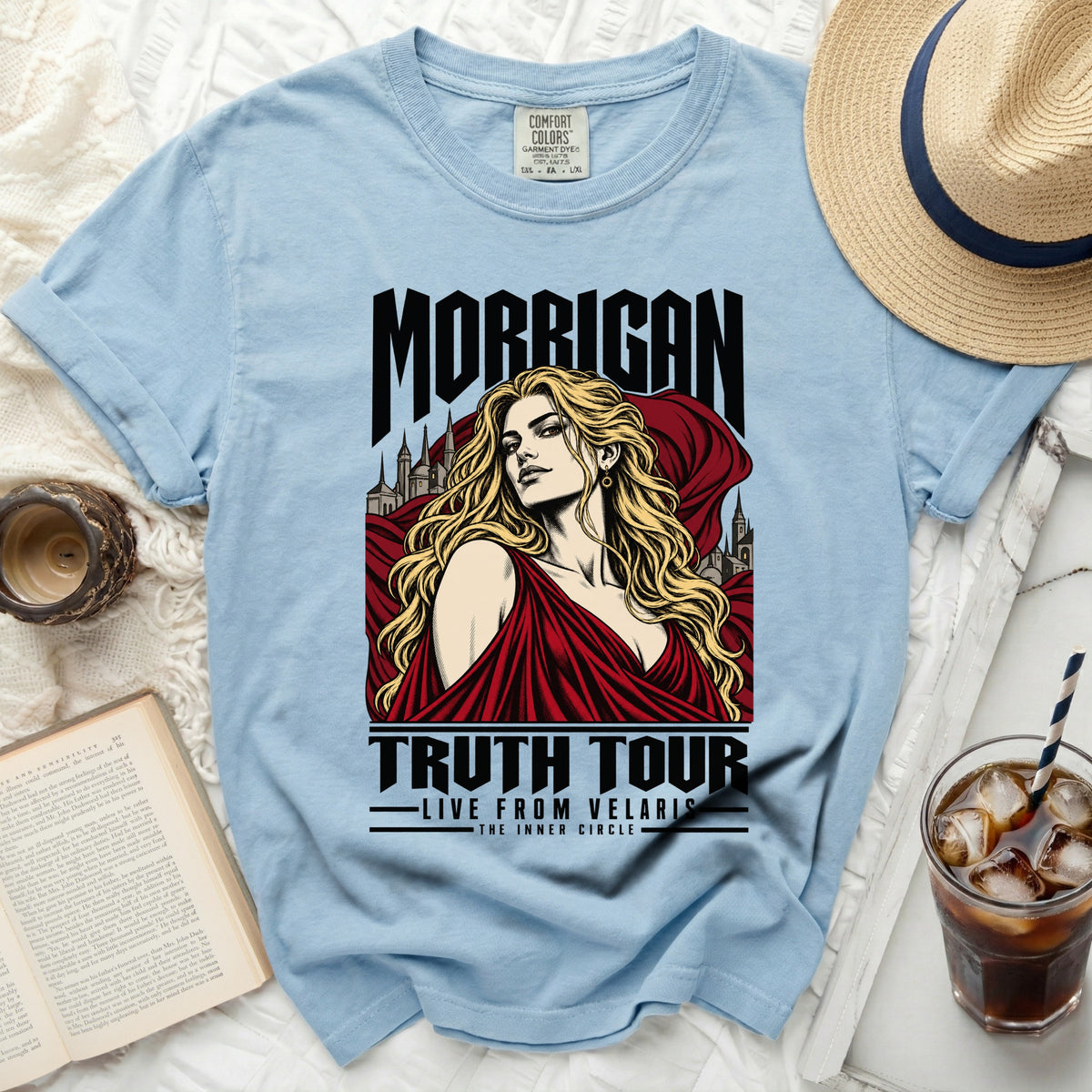 Light blue t-shirt with Morrigan Truth Tour graphic featuring a woman and castle.