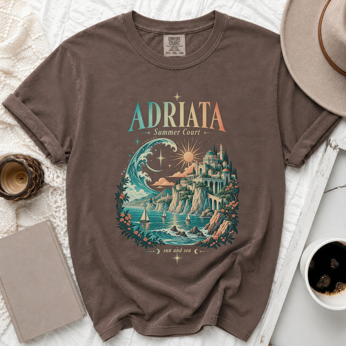 Brown t-shirt with "Adriata Summer Court" graphic of a coastal city and sailboats.