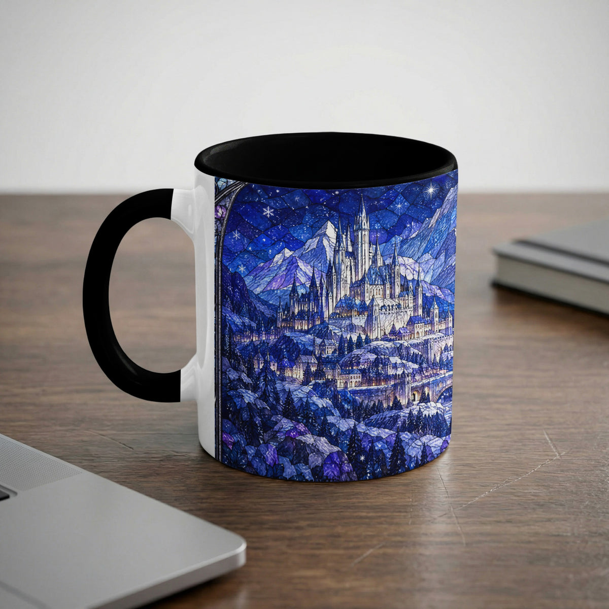 Black and white ceramic mug featuring a blue winter castle stained glass graphic on a wooden desk.