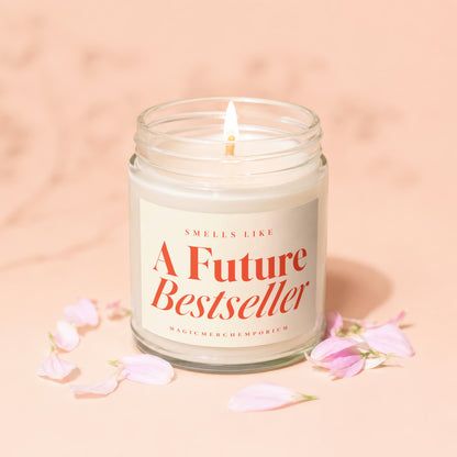 Candle with lit wick, "Smells Like A Future Bestseller" text in red.