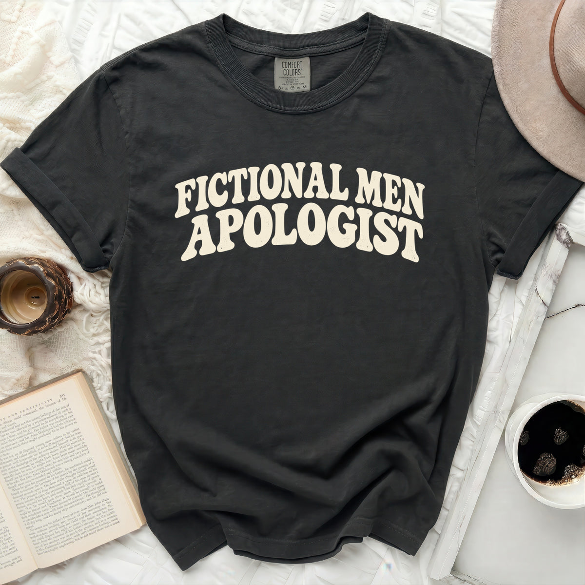 Black t-shirt with "Fictional Men Apologist" in cream text.