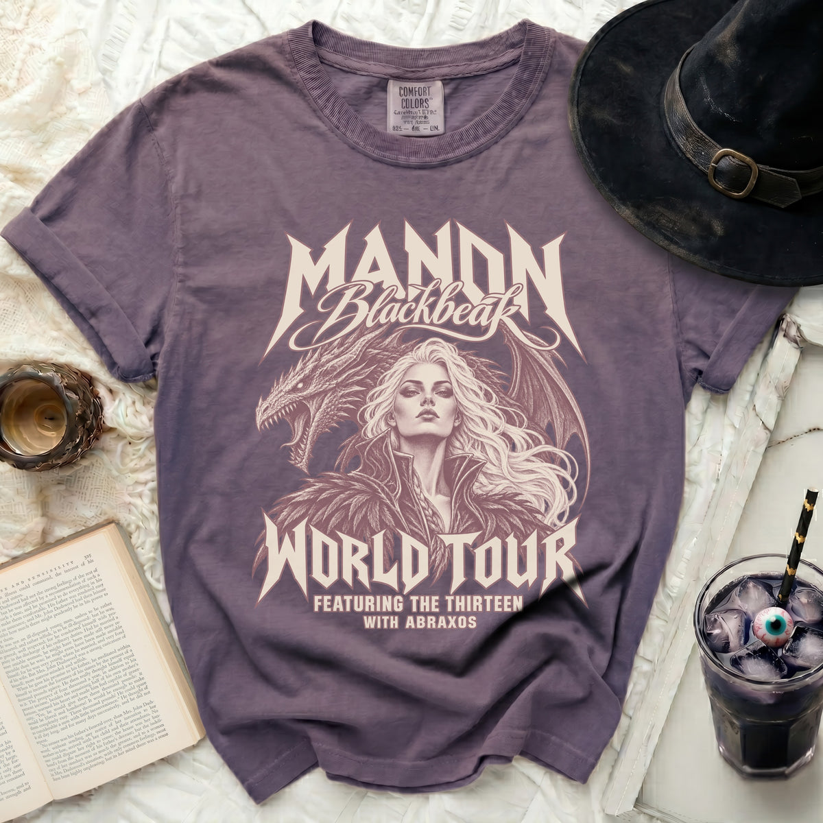 Purple t-shirt with Manon Blackbeak World Tour dragon and woman graphic.