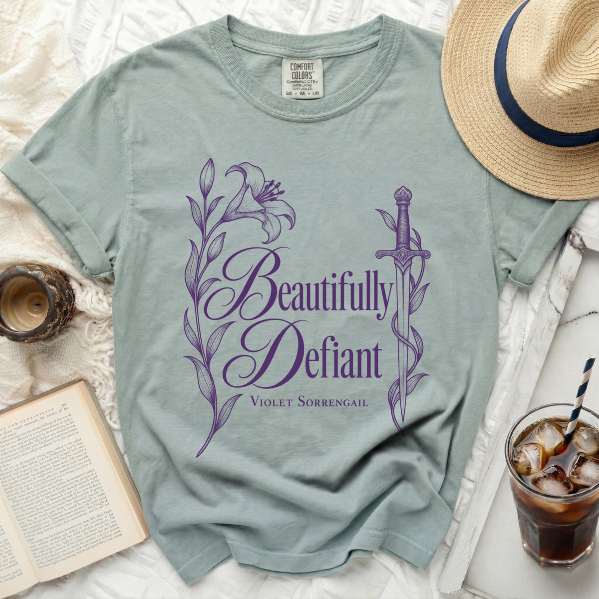 Light blue t-shirt with "Beautifully Defiant Violet Sorrengail" text and purple floral design.