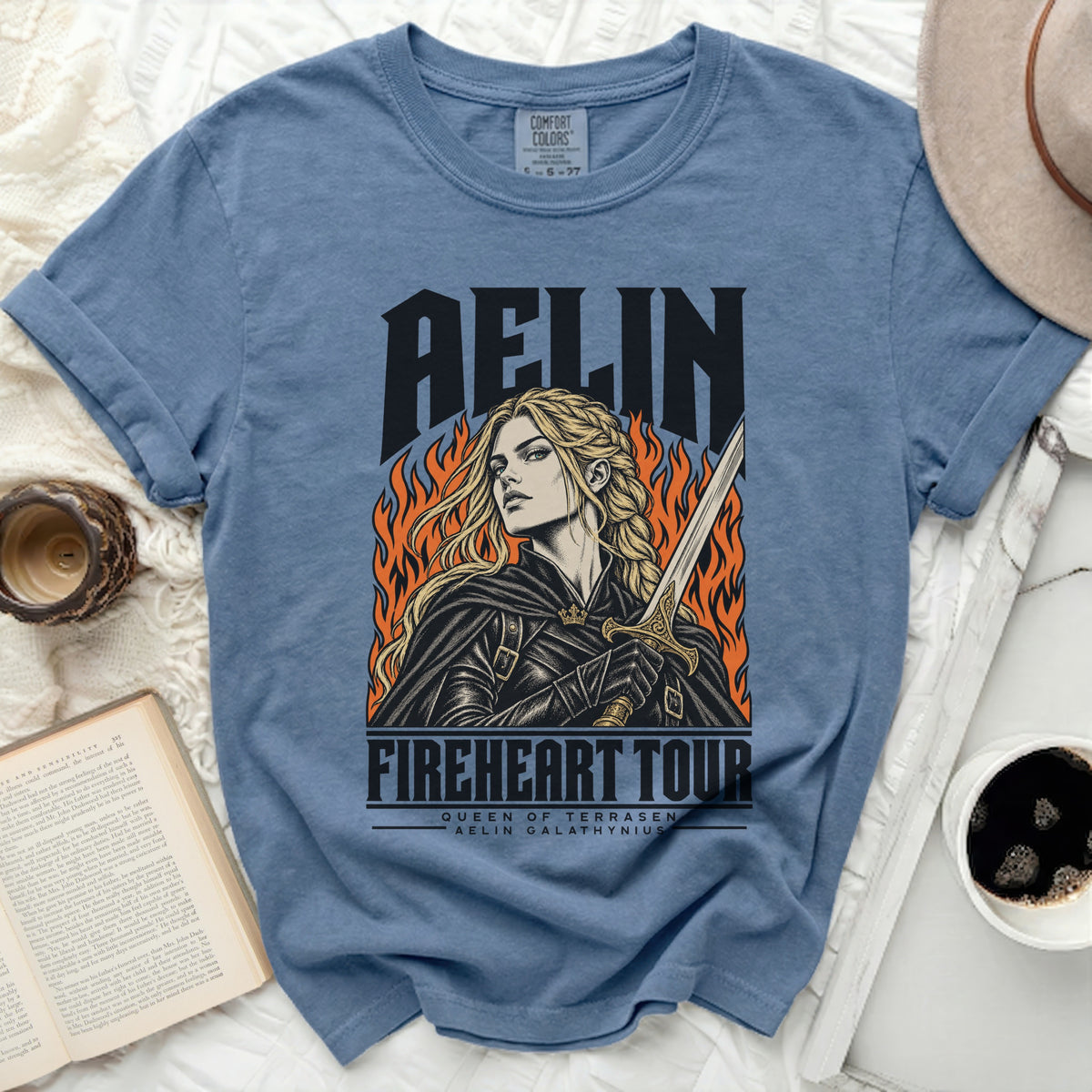 Blue t-shirt with Aelin "Fireheart Tour" graphic featuring a woman with a sword and flames.