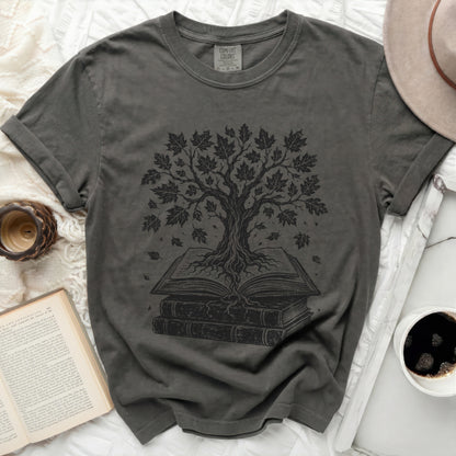 Grey t-shirt with black tree of knowledge graphic on open books.