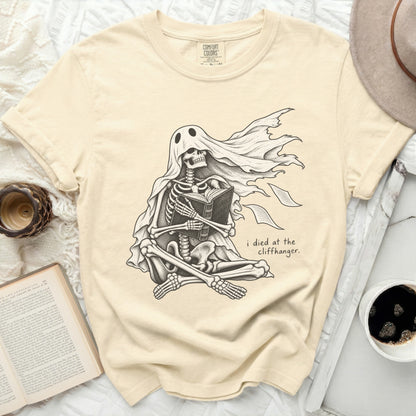 Skeleton ghost reading a book with text "i died at the cliffhanger."