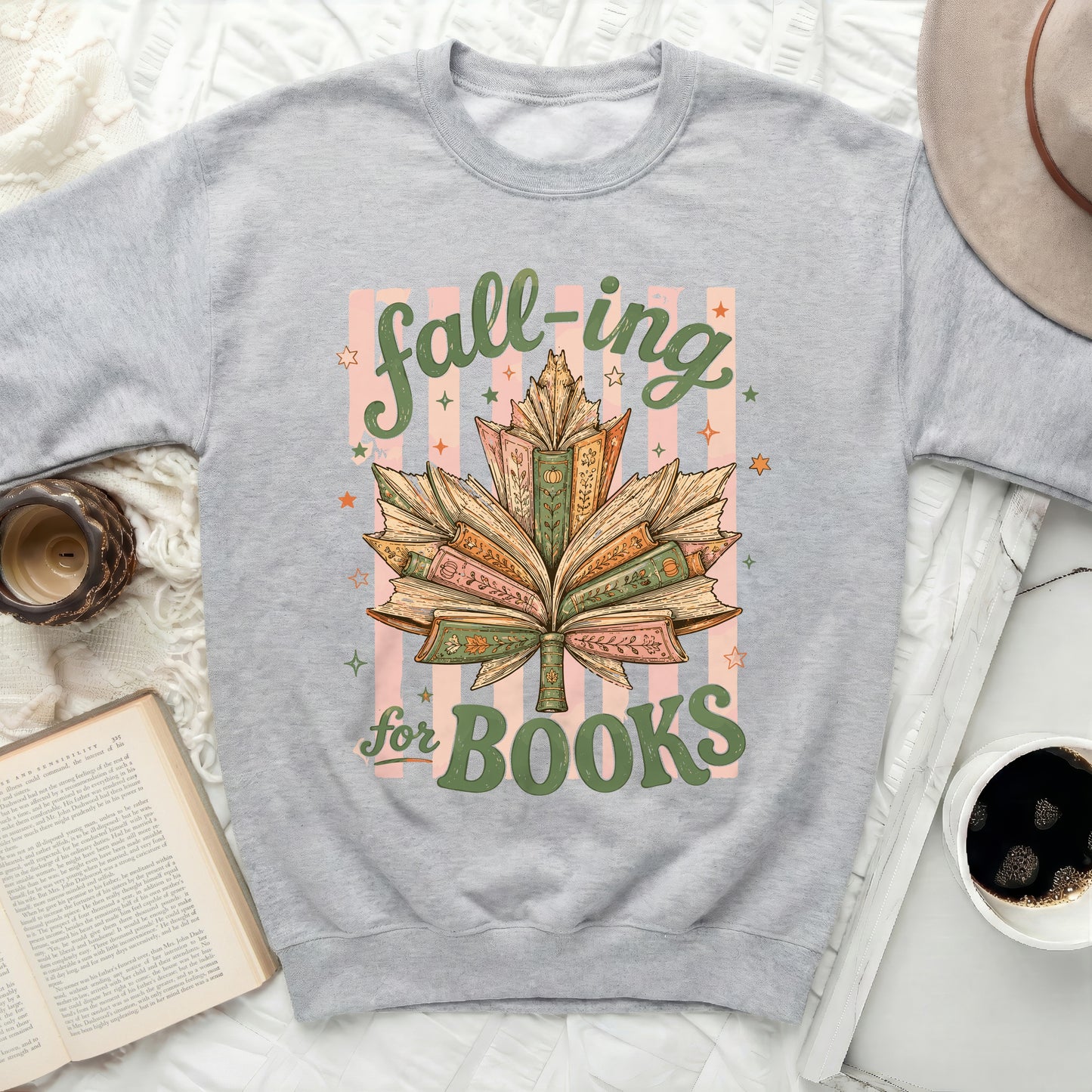 Gray sweatshirt with "Fall-ing for Books" slogan and book leaf design.