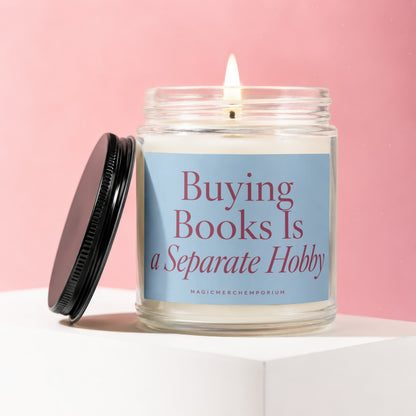 Candle with lid open, lit flame, says "Buying Books Is a Separate Hobby".