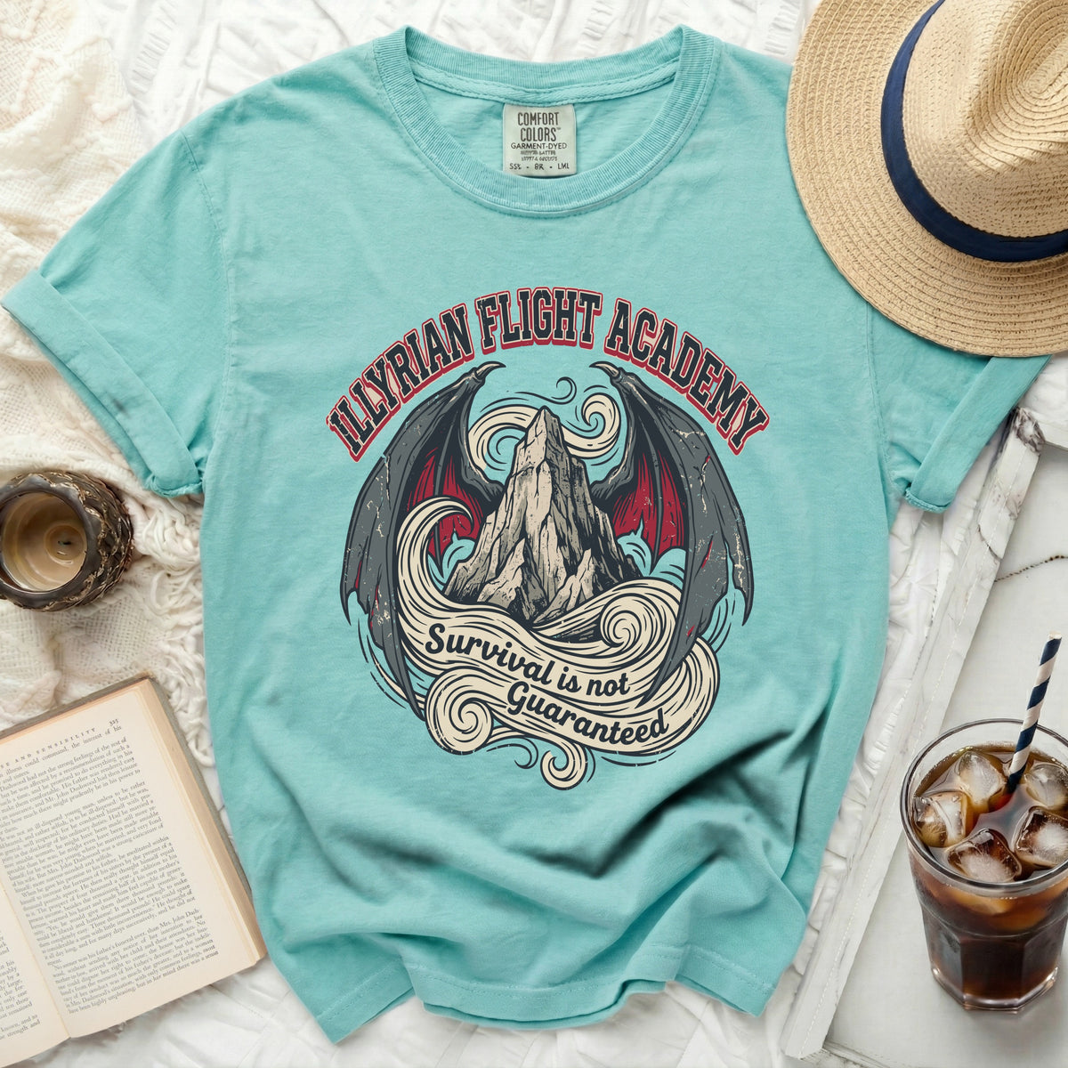 Aqua t-shirt with "Illyrian Flight Academy Survival is not Guaranteed" graphic.