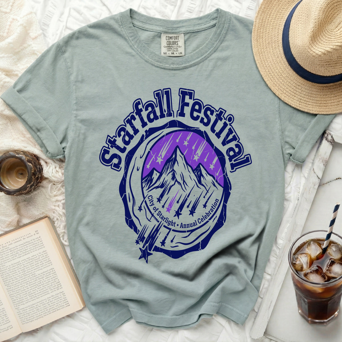Light green t-shirt with a navy and purple Starfall Festival graphic.