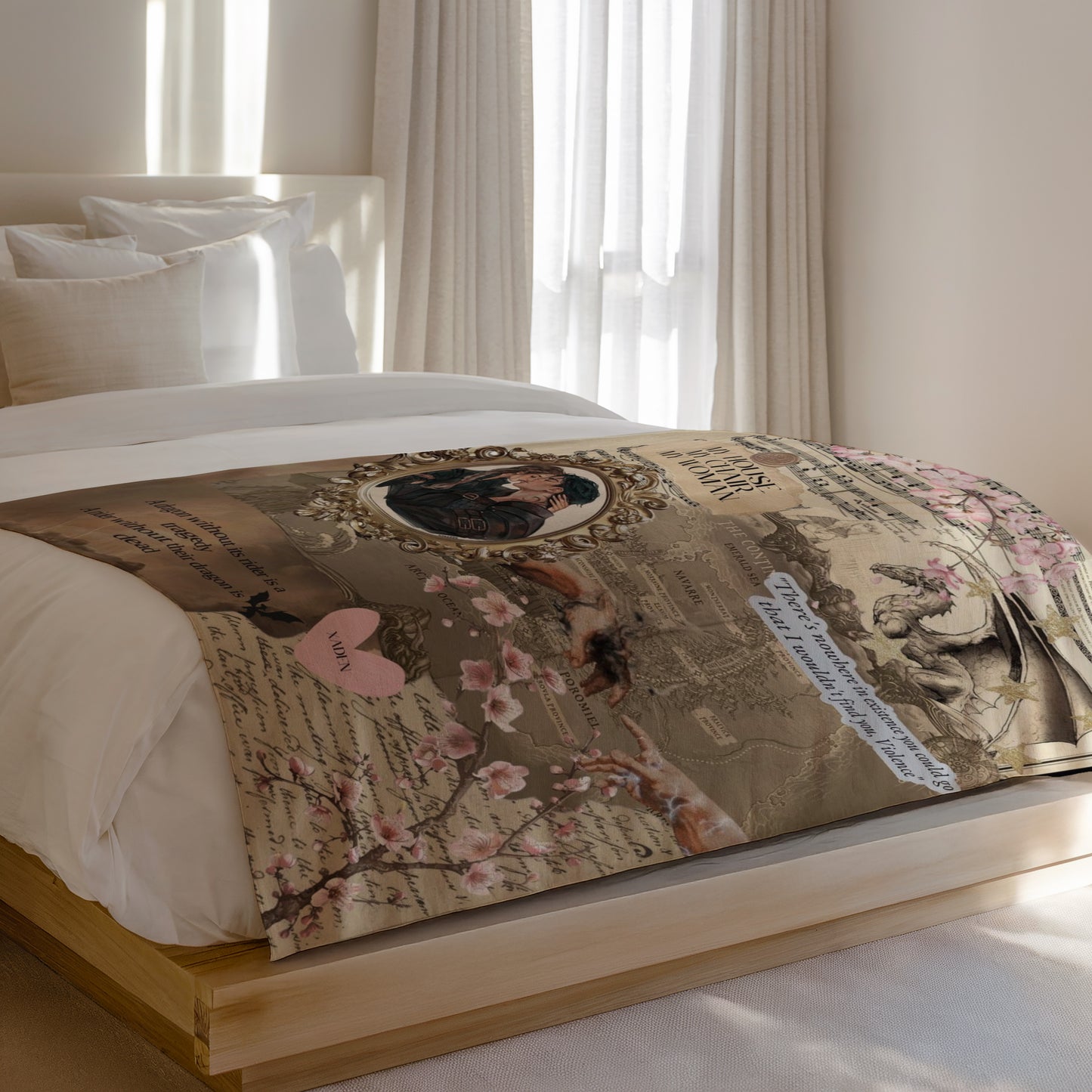Tapestry with romantic drawing, dragon, flowers, and text on a bed.