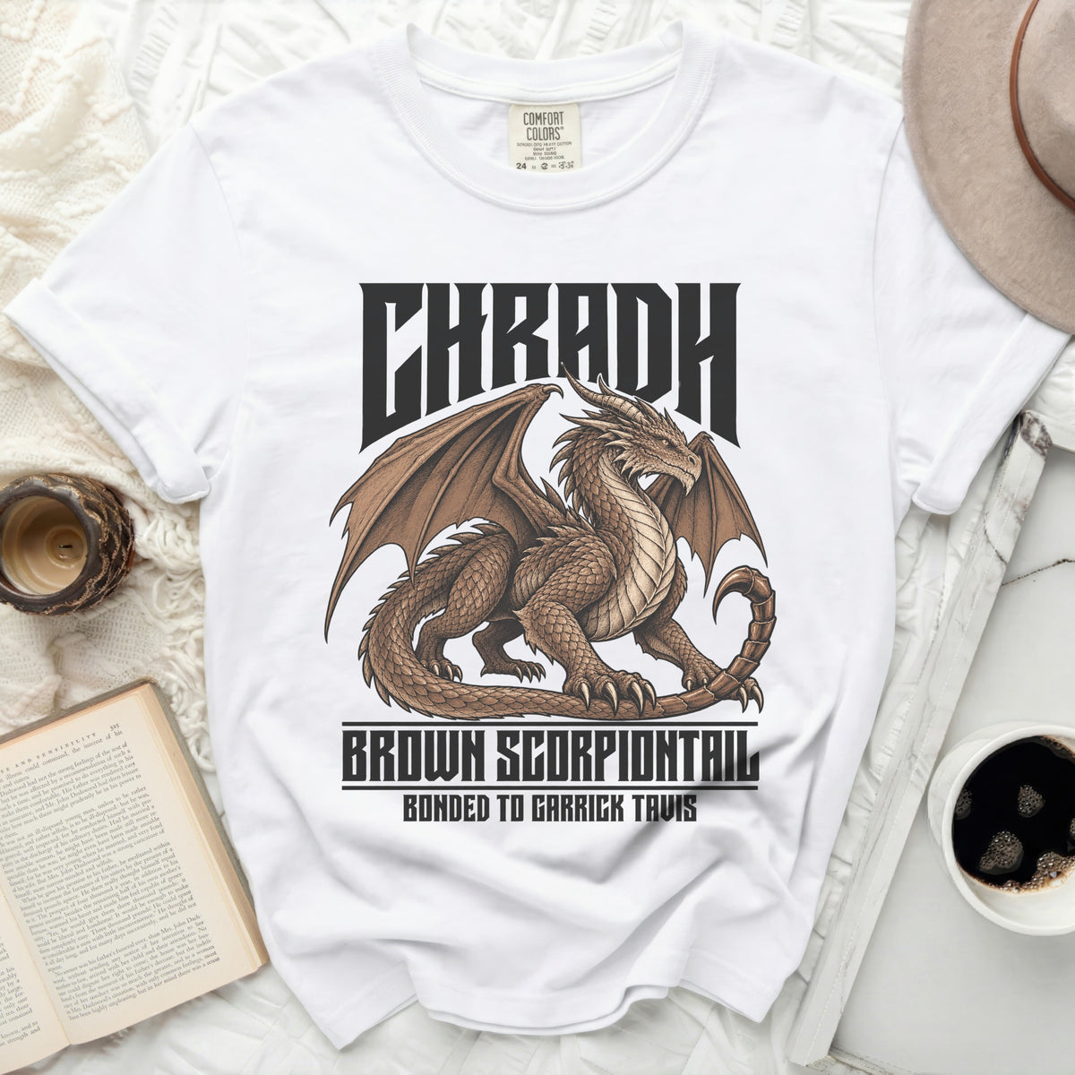 White t-shirt with brown dragon graphic and text "CHRADH BROWN SCORPIONTAIL BONDED TO GARRICK TAVIS".