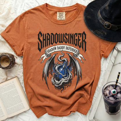 Orange t-shirt with "Shadowsinger Shadow Daddy Defender" graphic.