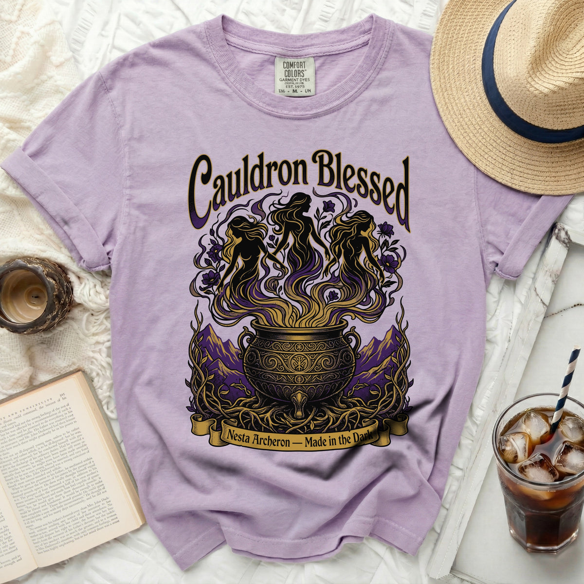 Purple t-shirt with "Cauldron Blessed Nesta Archeron" graphic.