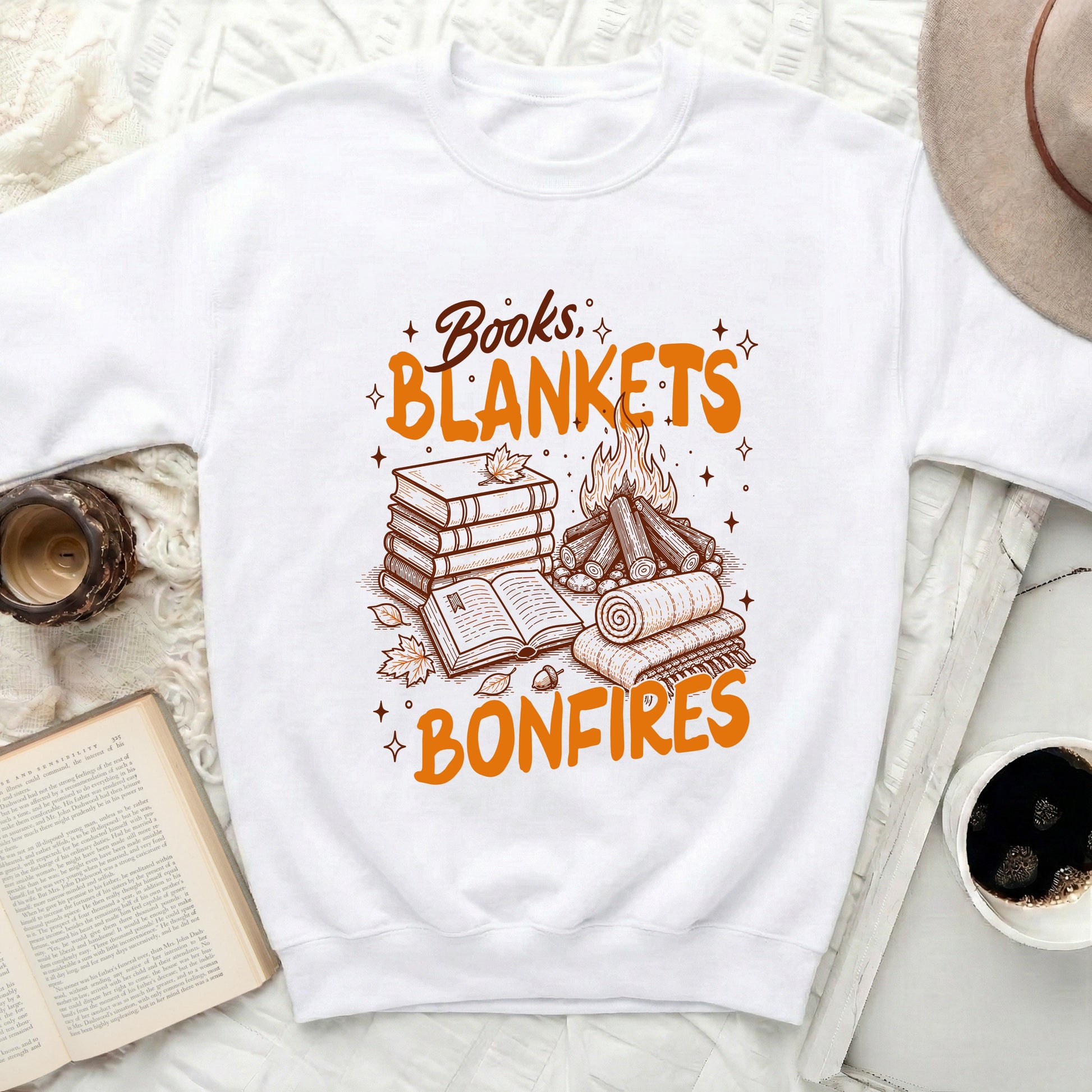 Graphic on white sweatshirt with text Books, Blankets, Bonfires, books, and campfire.