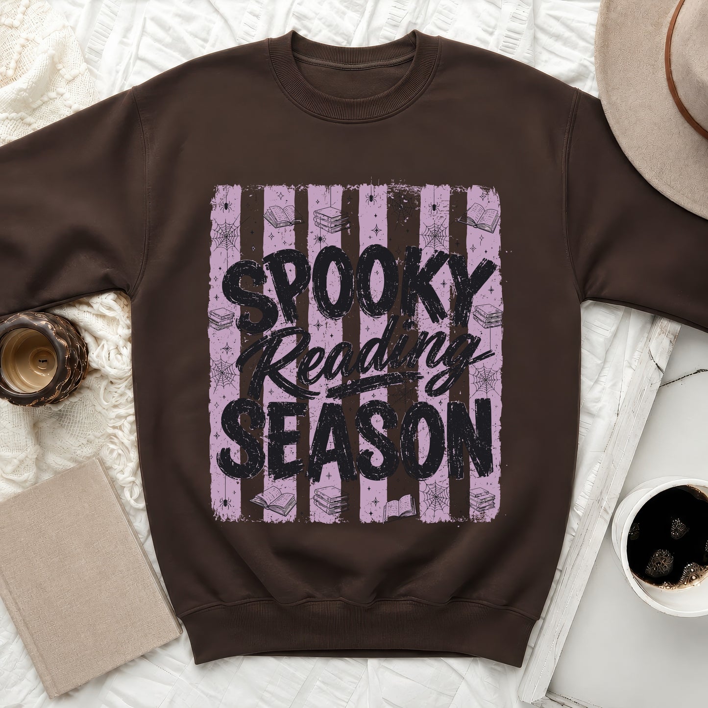 Brown crewneck sweatshirt with "Spooky Reading Season" text, books, and spiders.