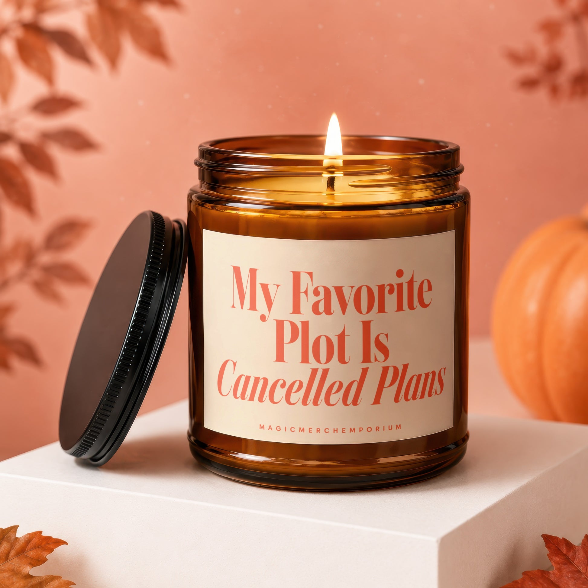 Amber jar candle with lit wick, "My Favorite Plot Is Cancelled Plans" text.