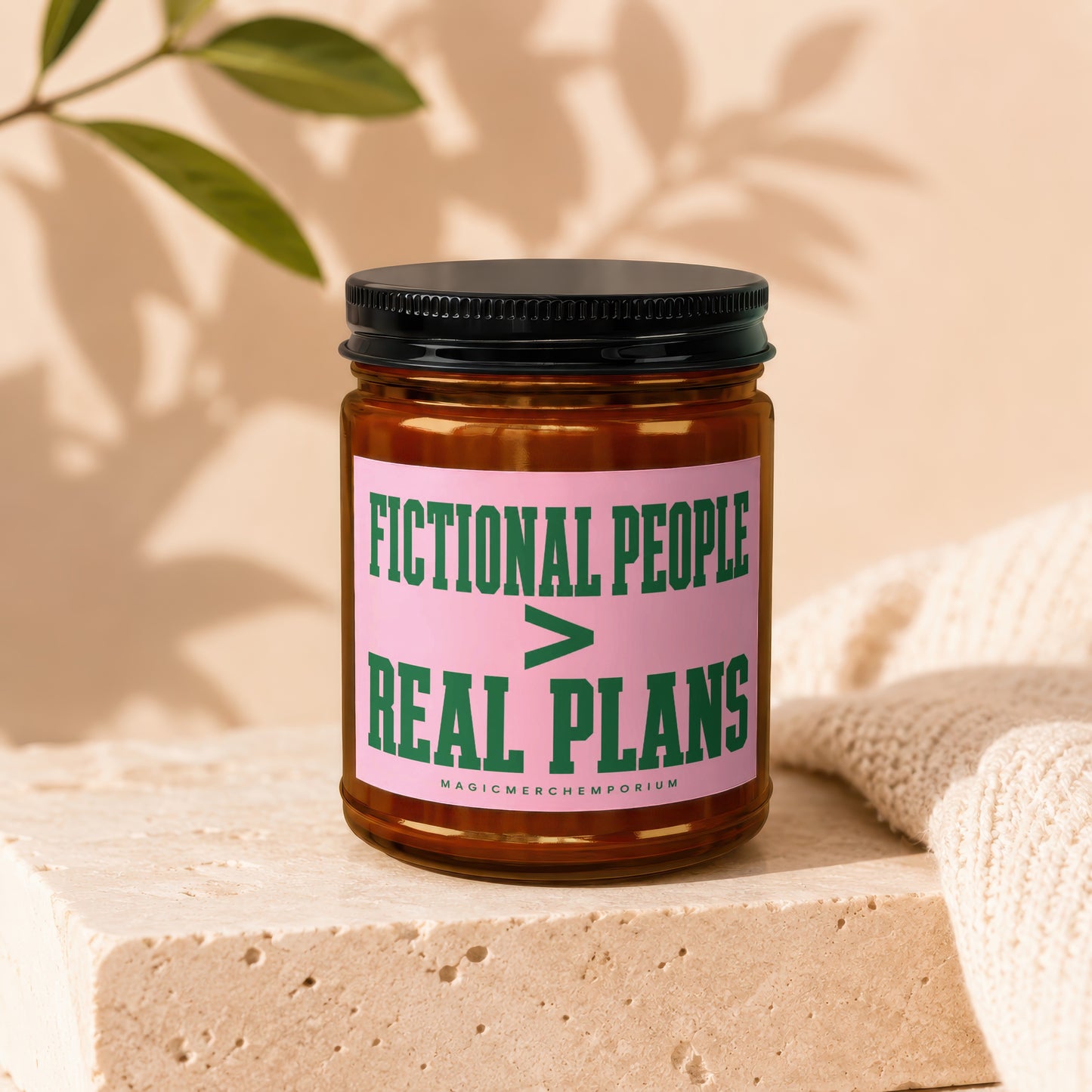 Amber jar candle with black lid labeled "Fictional People > Real Plans".