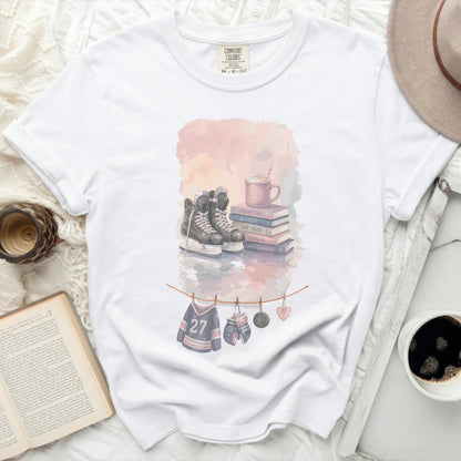 White t-shirt with watercolor hockey graphics and text.