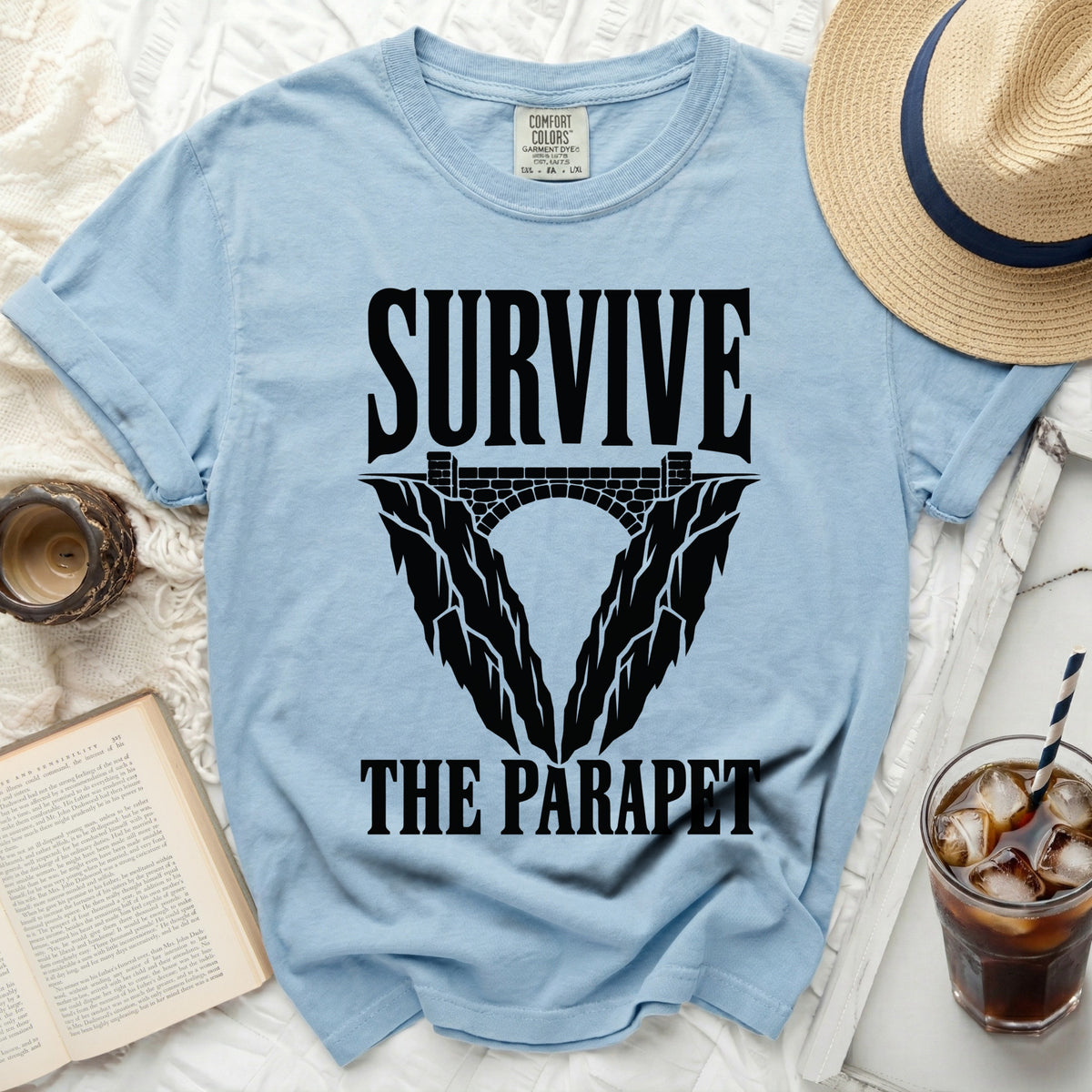 Light blue t-shirt with "SURVIVE THE PARAPET" graphic.