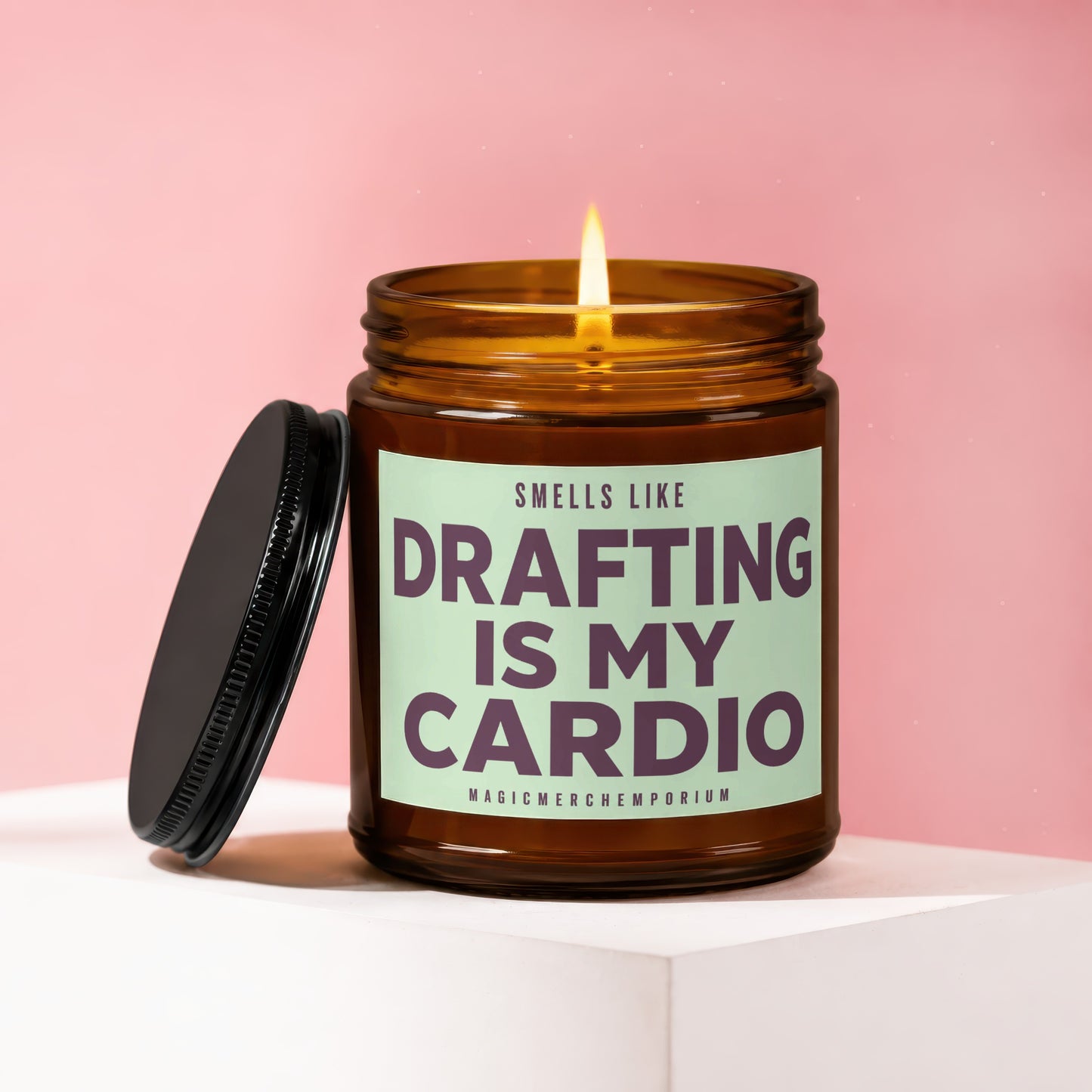 Amber jar candle with lit flame, "Smells Like Drafting Is My Cardio" text.