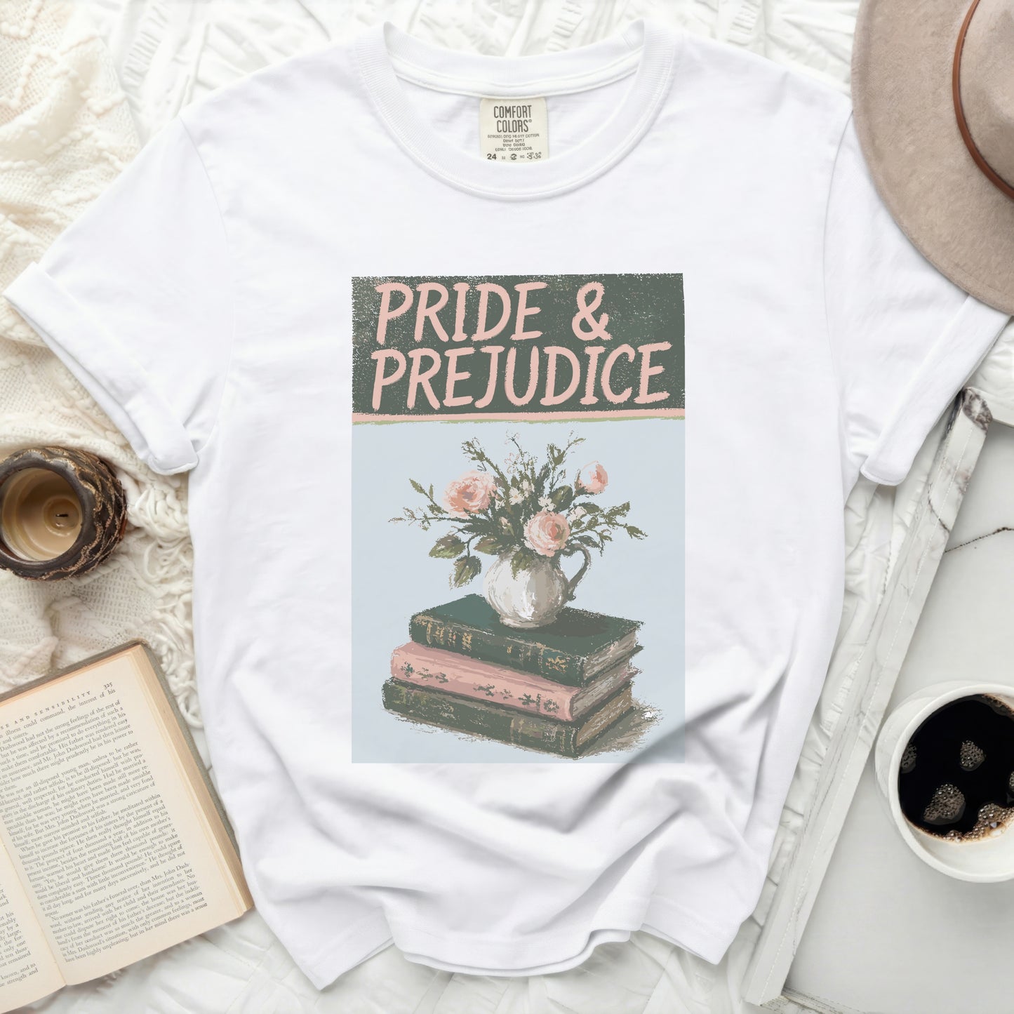 White t-shirt with "Pride & Prejudice" and flowers on books graphic.