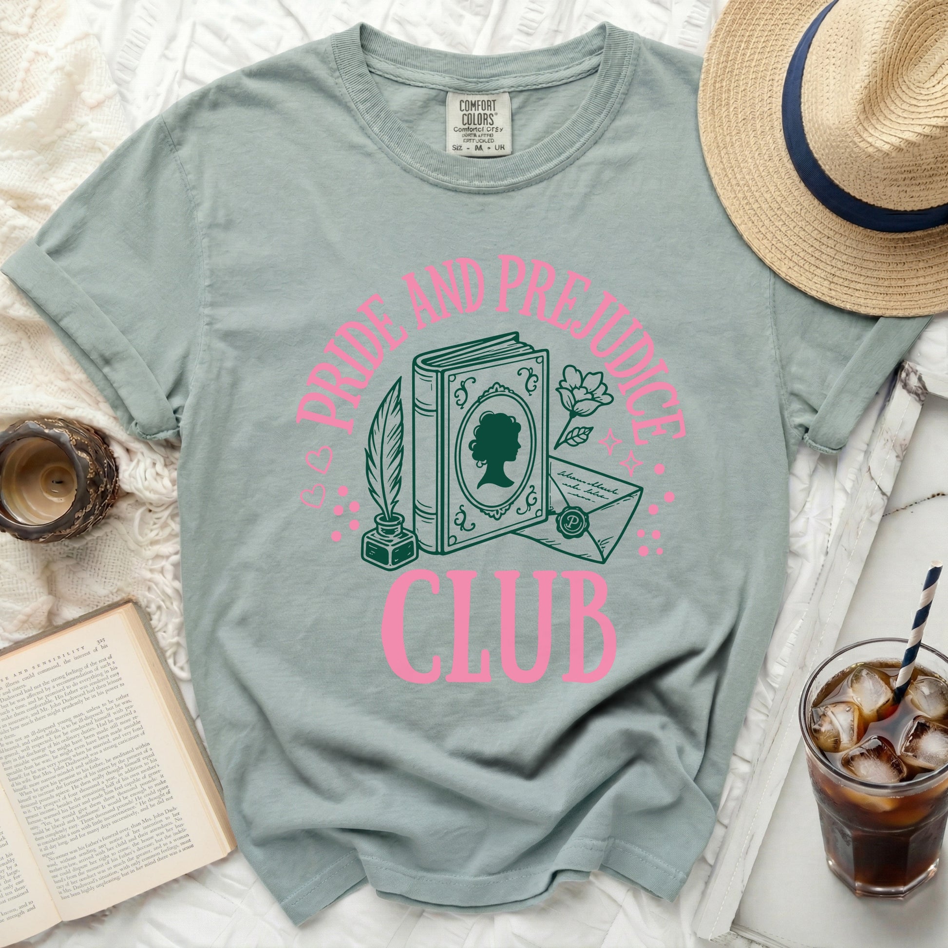 Green t-shirt with "Pride and Prejudice Club" pink graphic.