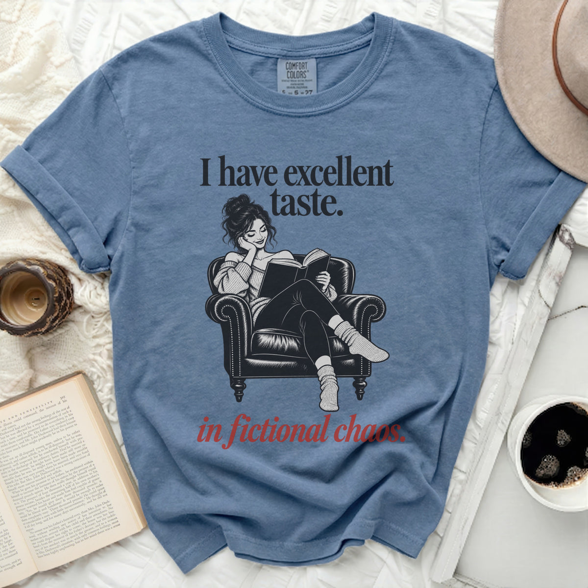 Blue t-shirt with "I have excellent taste. in fictional chaos." text and illustration.