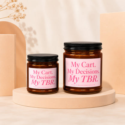 Two glass candles with pink labels reading "My Cart. My Decisions. My TBR."