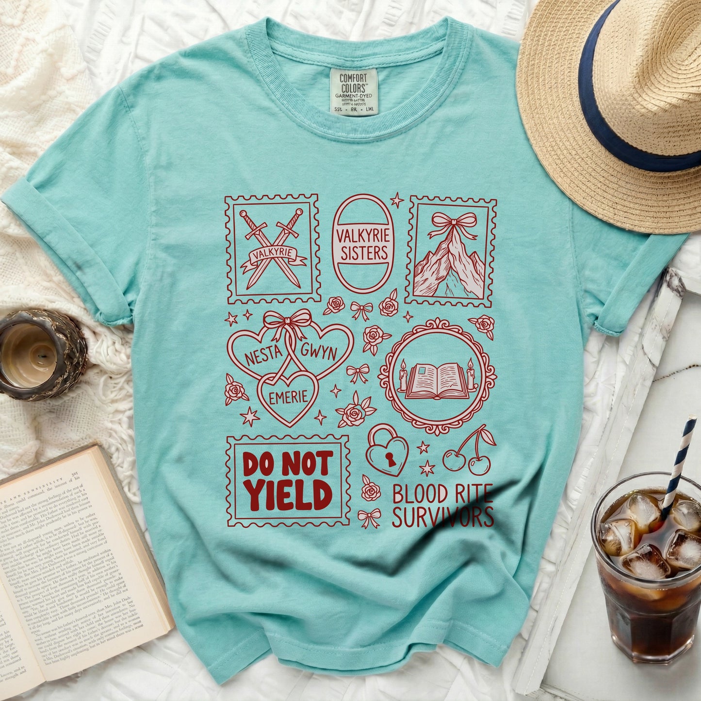 Aqua t-shirt with red graphic of stamps containing swords, mountains, book, and text.