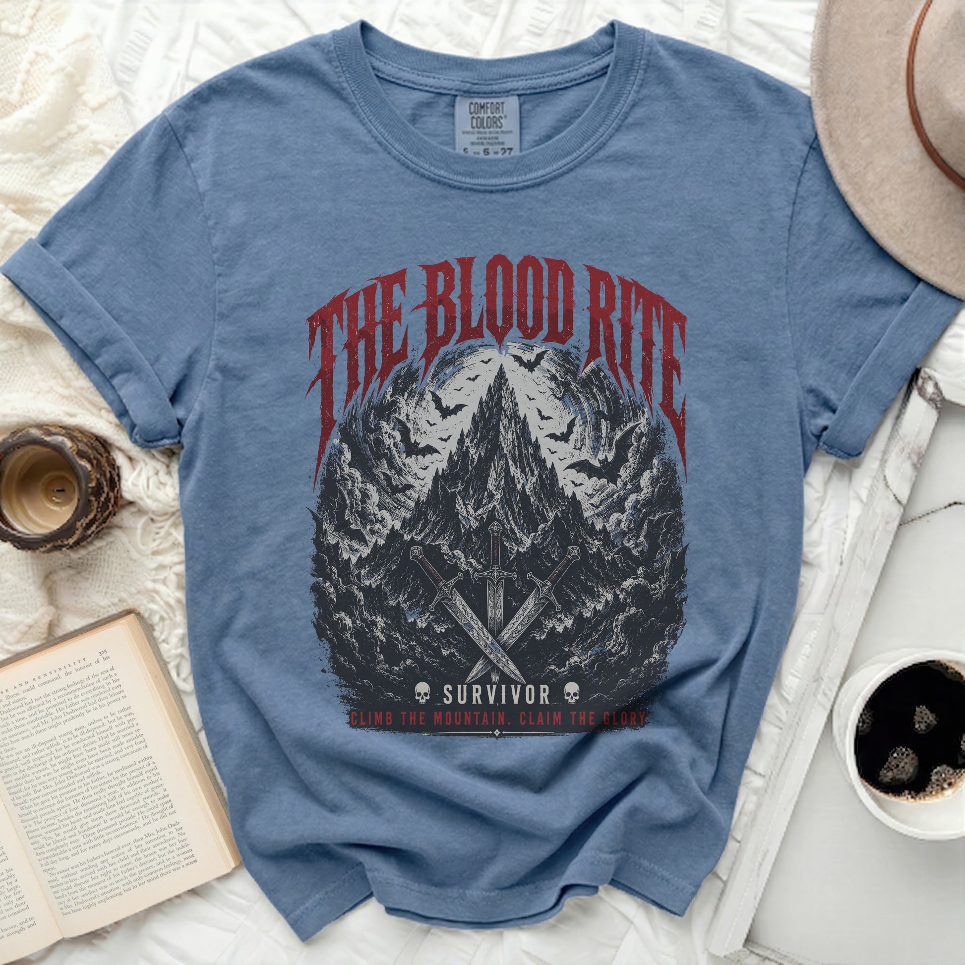 Blue t-shirt with "The Blood Rite Survivor" graphic and swords.
