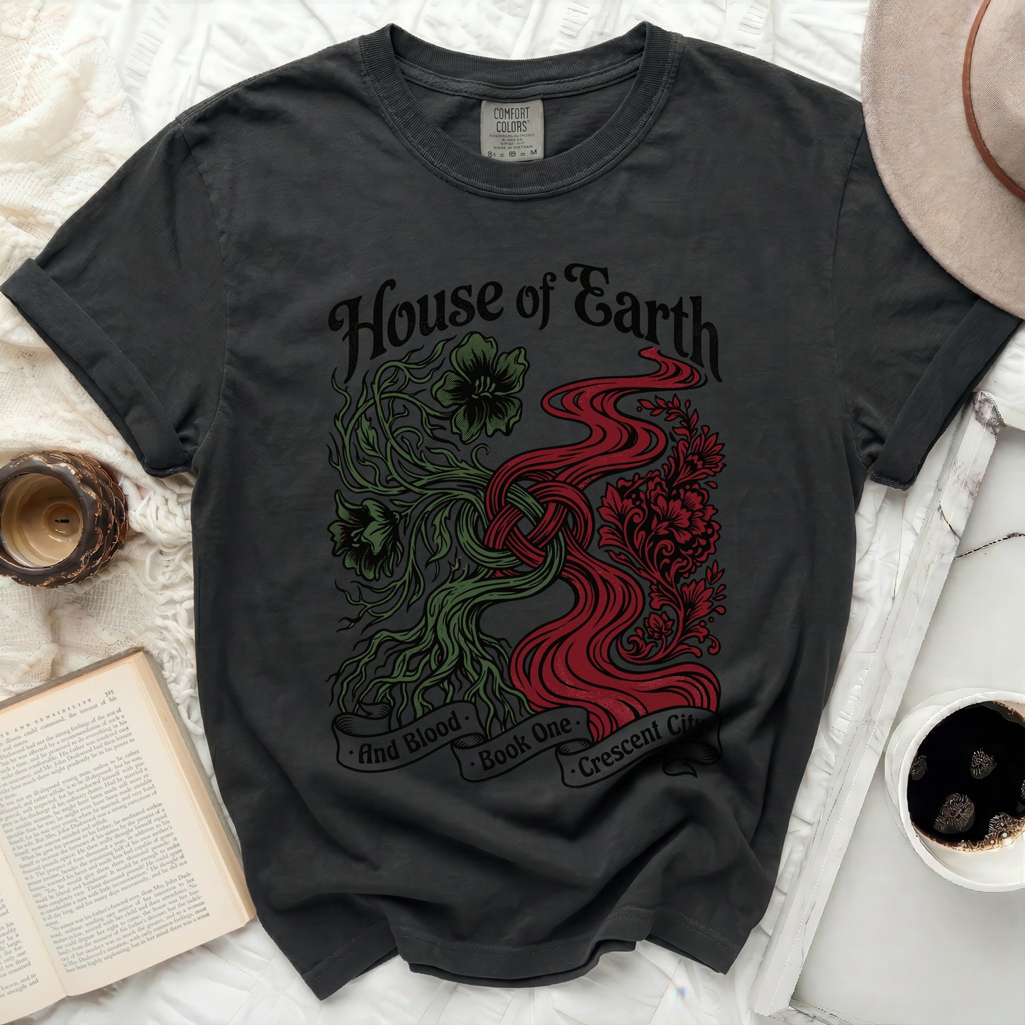 Dark t-shirt with "House of Earth and Blood" and "Crescent City" text design.