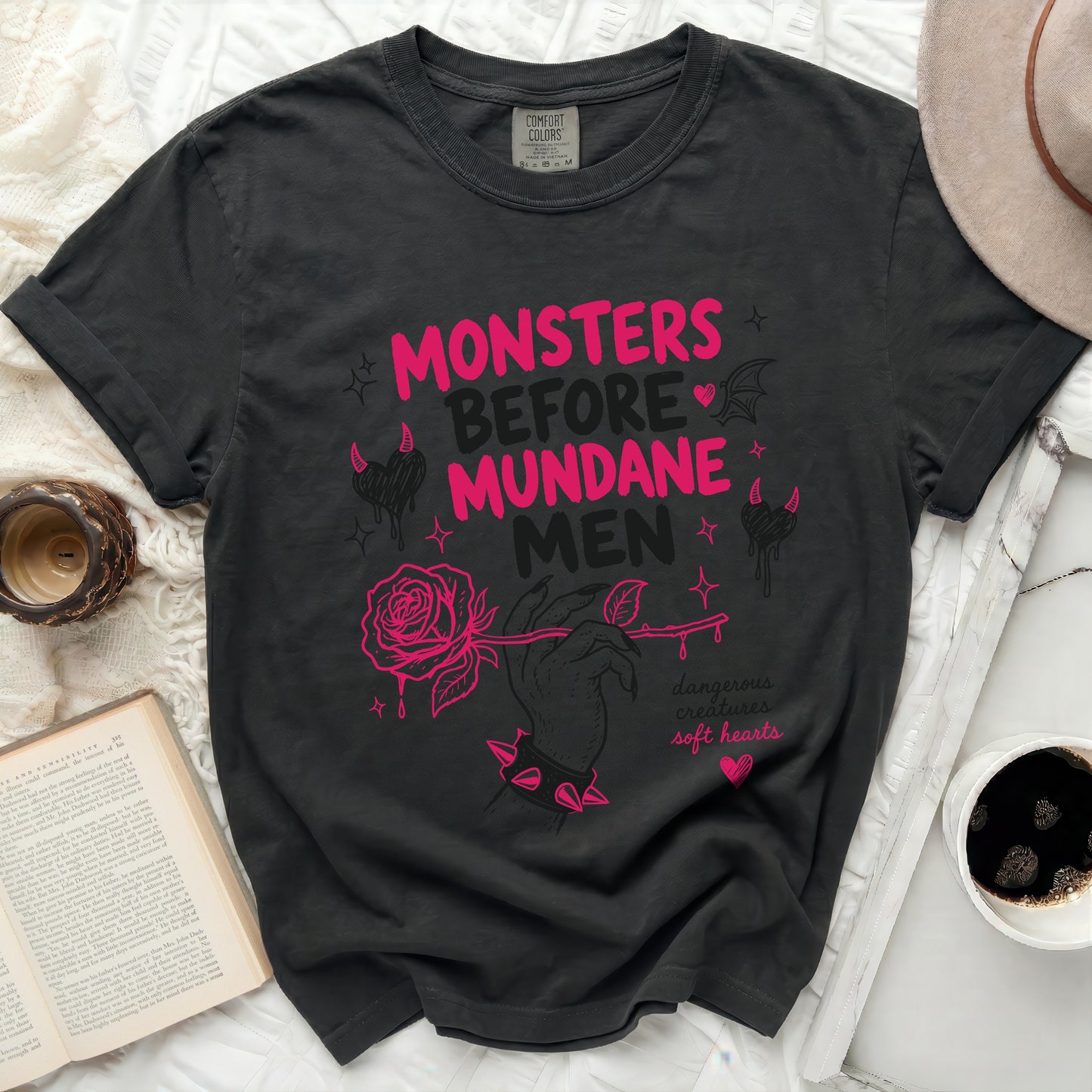 Black t-shirt with pink text "Monsters Before Mundane Men" and rose graphic.