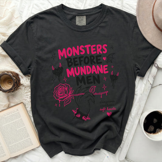 Black t-shirt with pink text "Monsters Before Mundane Men" and rose graphic.