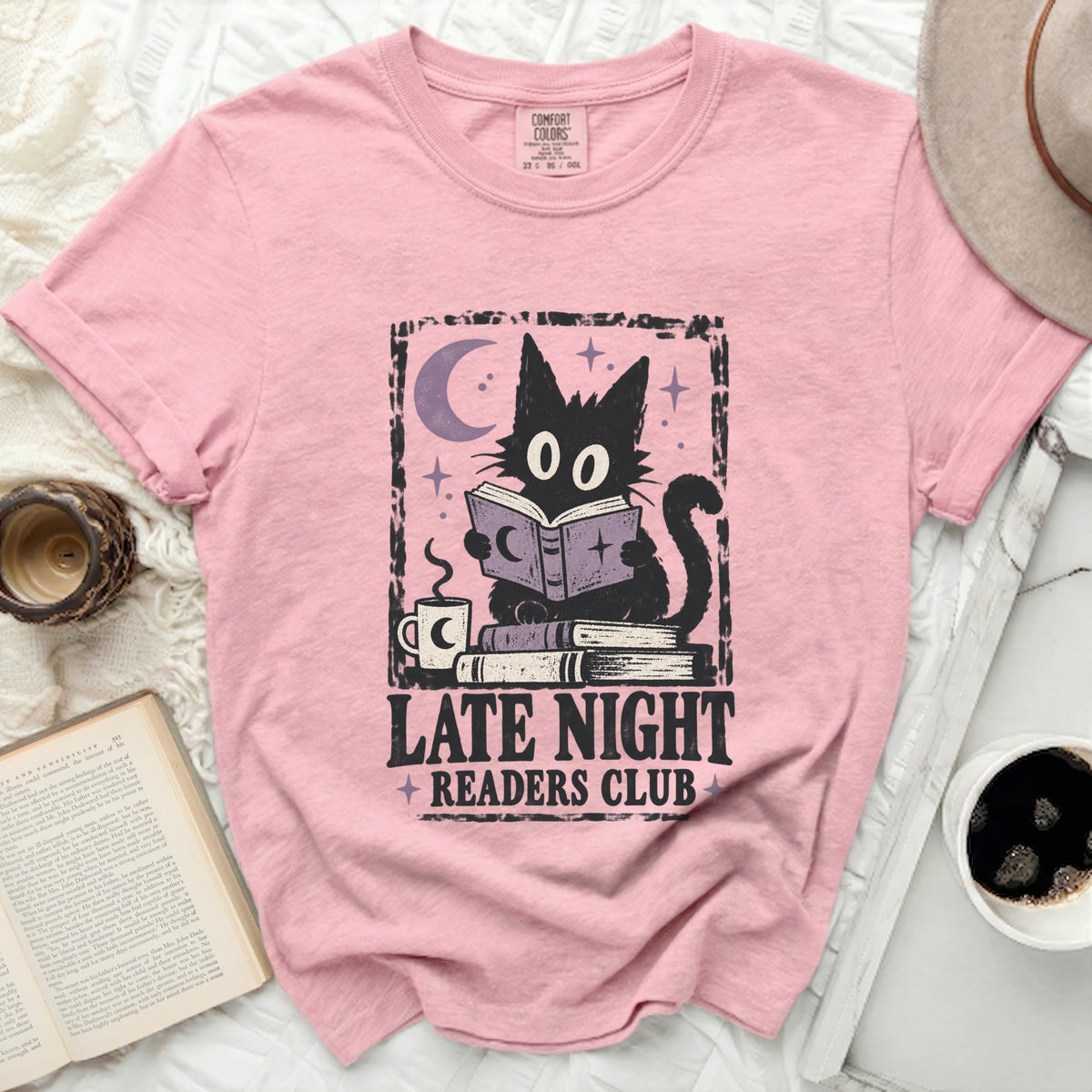 Pink t-shirt with black cat reading under moon, "LATE NIGHT READERS CLUB" text.