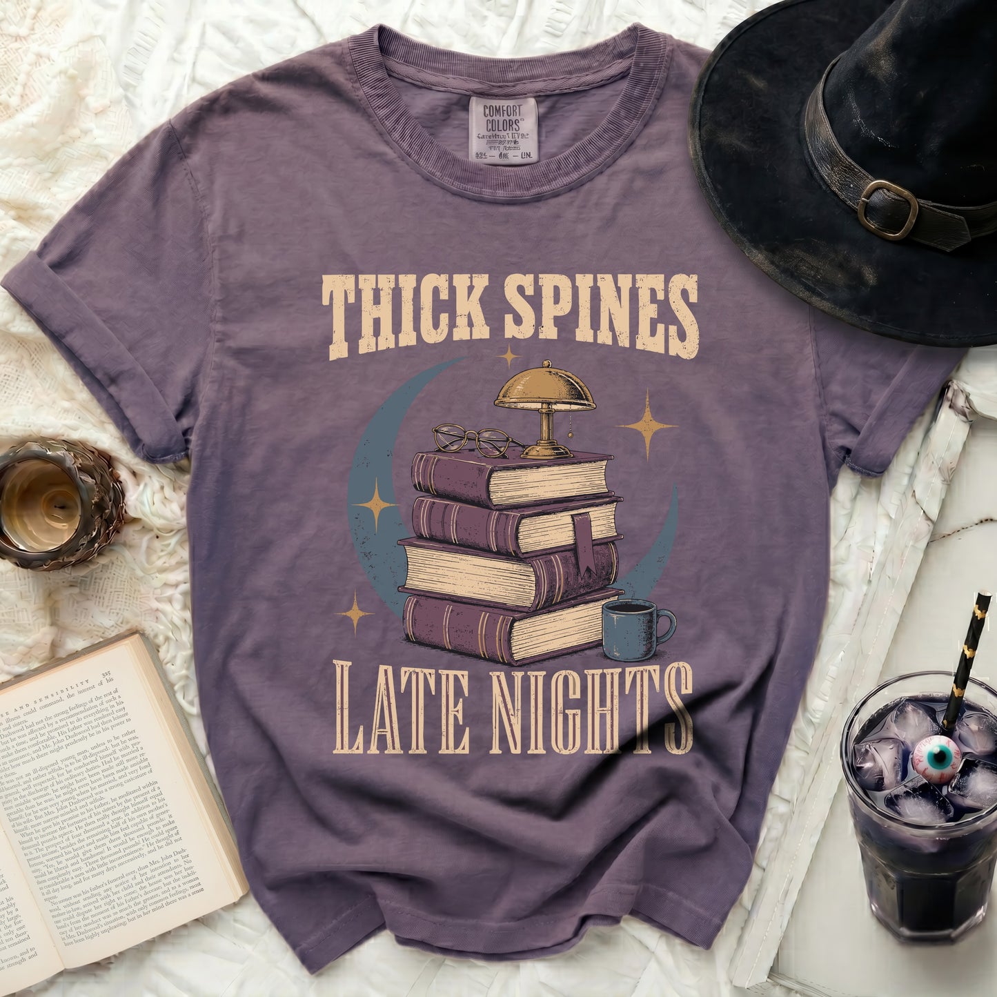 Thick spines late nights graphic tee with books, lamp, and moon.