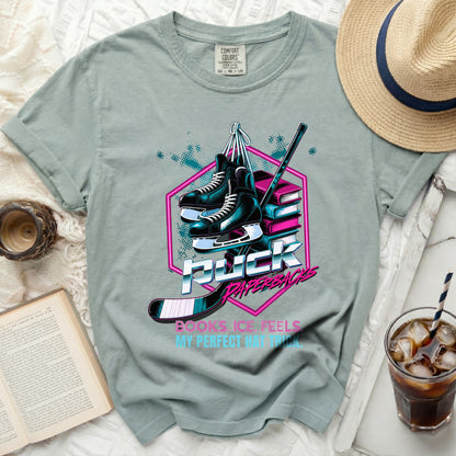 Green t-shirt with "Puck Paperbacks" text and hockey imagery.
